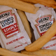 French fries in bottom of takeout bag with ketchup packets